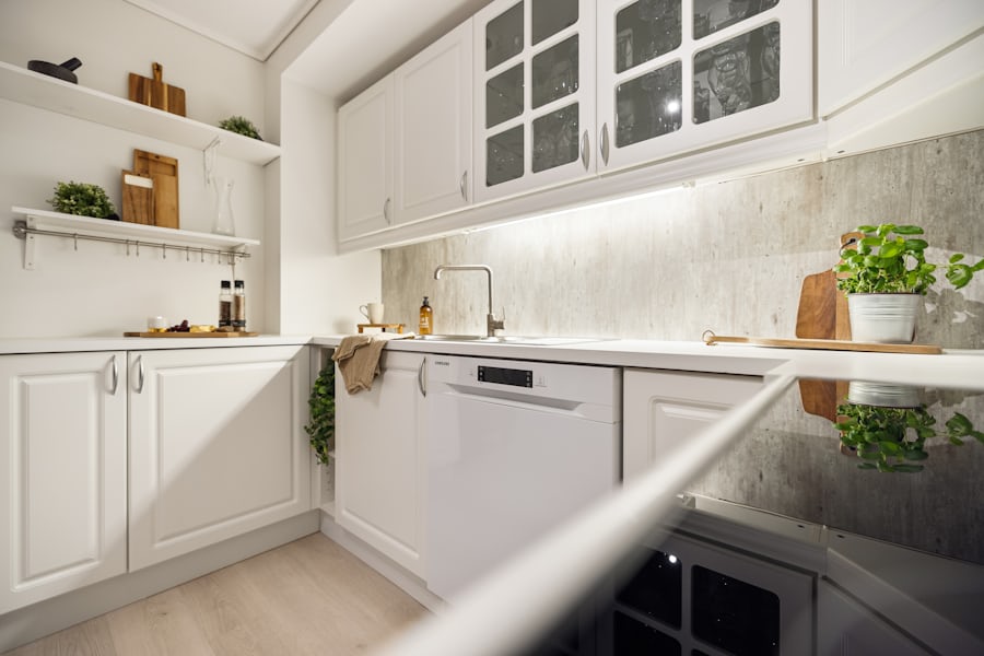 Modern white kitchen with integrated dishwasher and oak cabinets